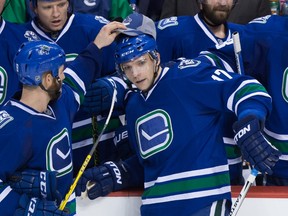 Canucks forward Brandon Prust (left) places a hat that was thrown onto the ice on the head of Radim Vrbata after Vrabata scored his third goal against the Sabres during the third period in Vancouver on Monday, Dec. 7, 2015. (Darryl Dyck/THE CANADIAN PRESS)