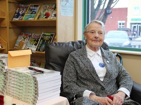 Anita-G. Côté proudly displays the book that she has written about her family and her former community.