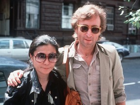 In this Aug. 22, 1980, file photo, John Lennon, right, and his wife, Yoko Ono, arrive at The Hit Factory, a recording studio in New York City. The death of Lennon, shot 35 years ago, still reverberates as a defining moment for a generation and for the music world. (AP Photo/Steve Sands, File)