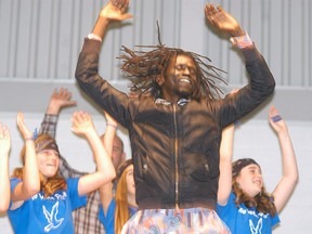 Musician Emmanuel Jal sings and dances during an appearance at Christ the King school on Tuesday, Nov. 24. Jal inspired students last year in Courtney Mellow's Grade 7/8 class to raise money to help ex-child soldiers in Sudan get an education.