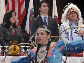 Prime Minister Justin Trudeau (C) stands with Justice Minister Jody Wilson-Raybould (L) and Assembly of First Nations National Chief Perry Bellegarde during an opening ceremony at the Assembly of First Nations Special Chiefs Assembly in Gatineau, Que., Dec. 8, 2015. REUTERS/Chris Wattie