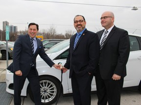 From left, Economic Development Minister Brad Duguid, Liberal MPP Glenn Thibeault and Transportation Minister Steven Del Duca show that charging up an electric vehicle is pretty straightforward. The trio announced during a stop at Toronto's Brick Works Tuesday December 8 2015 that a new $20-million grant program will spur the creation of a network of charging stations across the province. (ANTONELLA ARTUSO/Toronto Sun)