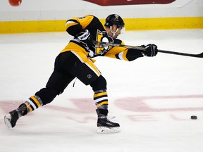 Pittsburgh Penguins forward Pascal Dupuis breaks his stick on a shot against the Montreal Canadiens in Pittsburgh, Wednesday, Nov. 11, 2015. (AP Photo/Gene J. Puskar)