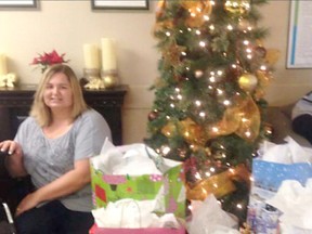 Various items are being collected for seniors at Lucknow’s Pinecrest Manor this week at Lucknow Travel. Pictured: Stacey van Leerzem sits beside gifts wrapped for Pinecrest Manor residents. (Submitted)