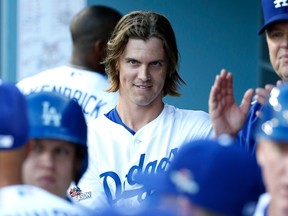 Zack Greinke of the Los Angeles Dodgers smiles from the dugout while taking on the New York Mets in Game 5 of the National League Division Series at Dodger Stadium on October 15, 2015 in Los Angeles. (Sean M. Haffey/Getty Images/AFP)