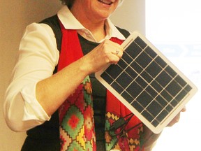 Cathy MacLellan with Ubiquity Solar shows a solar module while speaking with Seaway Kiwanis members at the Sarnia Golf and Curling Club Tuesday. Ubiquity Solar is in the process of starting a pilot plant in Sarnia. (Tyler Kula, The Observer)