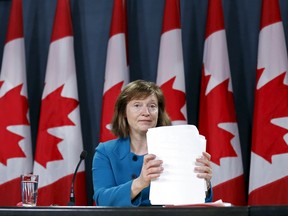 Canada's Information Commissioner Suzanne Legault shuffles papers during a news conference. (REUTERS/Chris Wattie)