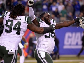 Jets defensive end Muhammad Wilkerson (96) and nose tackle Damon Harrison (94) celebrates beating the Giants in overtime at MetLife Stadium in East Rutherford, N.J., on Sunday, Dec. 6, 2015. (Robert Deutsch/USA TODAY Sports)