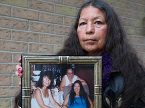 Mary Lou Smoke holds a photo of herself, her mom Shirley Lascelles, and her sister Debbie Sloss-Clarke in London, Ont. on Tuesday December 8, 2015. Sloss-Clarke was slain 18 years ago. Her killer has never been found. (DEREK RUTTAN, The London Free Press)