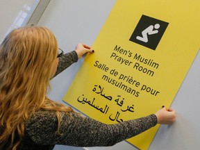 Signage being put up at a prayer area in the temporary port-of-entry designed to facilitate the entrance to Canada of Syrian refugees at Toronto Pearson International Airport Tuesday December 8, 2015. (Dave Thomas/Toronto Sun)