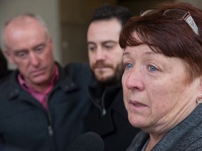 John Curry and his son Jordan listen to John's sister Lillian Curry speak to media following the sentencing of Shane Wood for the first degree murder of their brother Paul Curry in London, Ont. on Tuesday December 8, 2015. (DEREK RUTTAN, The London Free Press)