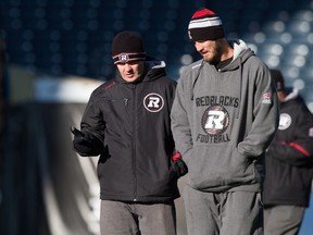 Ottawa RedBlacks offensive co-ordinator jason Maas, right, and heac coach Rick Campbell talk during practice on Nov. 28, the day before the Grey Cup game in Winnipeg. (The Canadian Press)