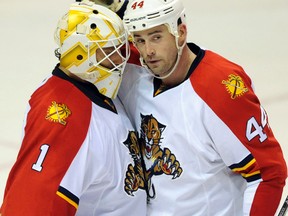 Florida Panthers goalie Roberto Luongo (1) celebrates with teammate Erik Gudbranson (44) after their 3-1 victory over the St. Louis Blues in an NHL hockey game, Tuesday, Dec. 1, 2015, in St. Louis. (AP Photo/Bill Boyce)