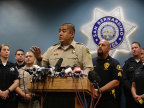 San Bernardino County Sheriff's detective Jorge Lozano, center, answers questions from reporters during a news conference with the first responders on the scene of last week's shooting, Tuesday, Dec. 8, 2015, in San Bernardino, Calif. Lozano was captured on video in a hallway of the Inland Regional Center telling employees and others who were stranded to follow him and that he would "take a bullet before you do." (AP Photo/Jae C. Hong)