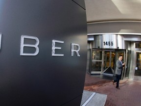 A man leaves the headquarters of Uber in San Francisco. (THE CANADIAN PRESS/AP-Eric Risberg files)