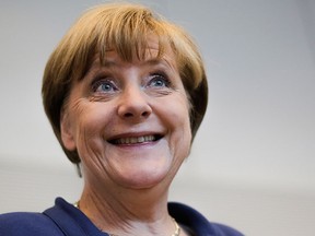 In this Thursday, July 16, 2015, file photo, German Chancellor Angela Merkel smiles as she arrives for a meeting in Berlin. (AP Photo/Markus Schreiber, File)