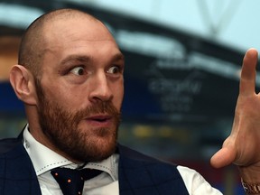 World heavyweight champion Tyson Fury speaks during a press conference in Bolton, England on November 30, 2015. (AFP PHOTO/PAUL ELLIS)