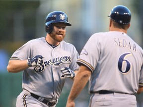 Milwaukee Brewers first baseman Adam Lind (left) rounds the bases after hitting a home run as Brewers third base coach Ed Sedar greets him at PNC Park in Pittsburgh. (Charles LeClaire/USA TODAY Sports)