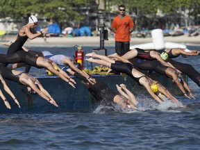 Athletes dive into the water at the start of the women’s marathon swimming test event ahead of the Rio 2016 Olympic Games on Copacabana Beach in Rio de Janeiro Sunday, Aug. 23, 2015. (AP Photo/Leo Correa)