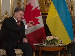 Canadian Prime Minister Justin Trudeau listens to Ukraine President Petro Poroshenko as they speak at the start of a bilateral meeting before the United Nations climate change summit in Paris, France, on Sunday, Nov. 29, 2015. THE CANADIAN PRESS/Adrian Wyld