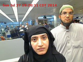 This July 27, 2014 file photo provided by U.S. Customs and Border Protection shows Tashfeen Malik, left, and Syed Farook, as they passed through O'Hare International Airport in Chicago. The husband and wife died on Dec. 2, 2015, in a gun battle with authorities several hours after their assault on a gathering of Farook's colleagues in San Bernardino, Calif. (U.S. Customs and Border Protection via AP, File)