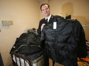 Captain Rodney Bungay, executive director of the Salvation Army Winnipeg, holds up a winter jacket -- one of few left behind by thieves.