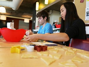 Nicolas Valdes Paleta and Claire Chiang of Trinity College School make cookies at Highland Shores Childrenís Aid Society on Wednesday December 9, 2015 in Belleville, Ont. The students were there as part of the school's Week Without Walls initiative which saw students helping out at a community service organization of their choice.