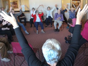 Dance instructor Amy Booth, right, leads a dance class for people with Parkinson's disease, their caregivers and partners, at a retirement residence in Kingston. (Michael Lea/The Whig-Standard)