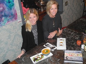 Kristen Taylor, left, and Liz Price-Kellogg with some of the dishes from their yoga cookbook. (Wayne Lowrie/Postmedia Network)