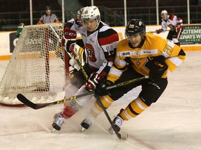 Ottawa 67's forward Travis Barron and Kingston Frontenacs captain Roland McKeown battle for position as the teams met at TD Place on Wednesday, Dec. 12, 2015. (Chris Hofley/Ottawa)