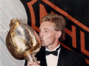 Wayne Gretzky kisses the Hart Trophy at the NHL Awards ceremony in 1989. Would the NHL ever decide to rename their awards to honour modern-day players and coaches? (Veronica Henri/Toronto Sun/Files)