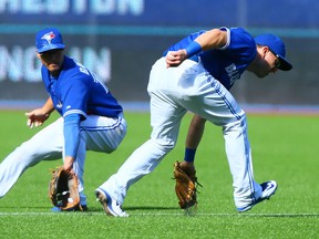 Blue Jays’ Darwin Barney chases a ground ball last season. Reports suggest Barney will be back with the Jays next season. (Dave Abel/Toronto Sun)
