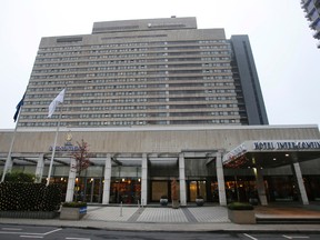 Flags fly in front of the Hotel Intercontinental in Frankfurt, Germany, on Dec. 10, 2015. German prosecutors say they have arrested five South Koreans on suspicion of murder following the death a 41-year-old woman in an apparent exorcism ritual in a room in the hotel, prosecutors said. (AP Photo/Michael Probst)