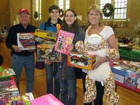 Students Carlie Thompson and Emily Laird, centre, with toys and games for The Christmas Shoppe.