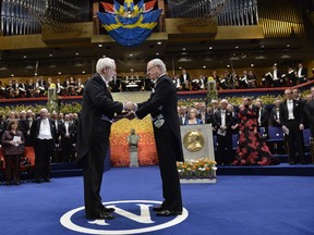 The 2015 Nobel physics laureate professor Arthur B. McDonald of Canada, left, receives his award from King Carl Gustaf of Sweden, during the 2015 Nobel prize award ceremony in Stockholm, Thursday, Dec. 10, 2015. (Jonas Ekstromer/TT News Agency via AP)