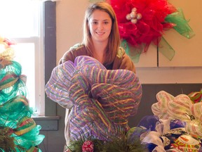 Dungannon Christmas in the Country brought out crowds on Dec. 5, 2015. Pictured: Rachael Nivins shows off a handmade bow she was selling at her wrapping and decorating table. (Darryl Coote/Kincardine News)