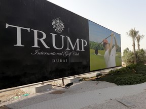 A file picture taken on  August 12, 2015 shows photo of US real-estate magnate Donald Trump playing golf on a billboard at the Trump International Golf Club Dubai in the United Arab Emirates (UAE). The prestigious golf club being developed in Dubai appeared to have withstood, so far, calls to boycott the US presidential hopeful, following his controversial call to bar Muslims from entering the United States. Trump's UAE partner sought to seperate business from his political statements. AFP PHOTO / KARIM SAHIB
