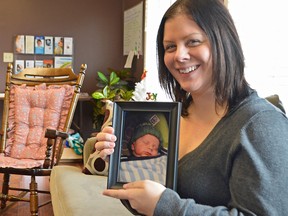 Nina Caleffi holds a picture of her son Ashtyn, now two years old, in the Refuge Pregnancy Resource Centre. Caleffi turned to the RPRC before she had Ashtyn, which gives her a relatable perspective as the new facility director.