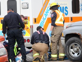 Emergency personnel attend to an 83-year-old Dresden, Ont. man who was struck by a vehicle while walking through the parking lot of the Walmart store in Chatham, Ont. around 10:30 a.m. on Thursday December 10, 2015. Chatham-Kent police said the victim was transported to hospital for medical attention. Police report the driver, a 77-year-old Chatham man, was not physically injured. No charges are being laid, police said. (Ellwood Shreve/Chatham Daily News/Postmedia Network)