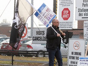 Todd Hockey, a correctional officer at the Ottawa-Carleton Detention Centre, walks on the picket line  out front of the Innes Rd. jail Thursday, Dec. 10, 2015.
MATT DAY/OTTAWA SUN