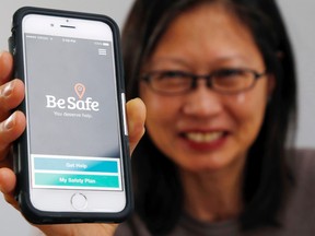 Luke Hendry/The Intelligencer
Lily Lee of Youthab holds a phone running the Be Safe mental health app in Belleville. Aimed at people ages 14 to 24, it helps in times of crisis by providing tips and links to services.