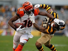 Bengals receiver A.J. Green (right) attempts to shed the Steelers' Antwon Blake before both being called for face-mask penalties during 4th quarter NFL action in Pittsburgh on Nov. 1, 2015. (Justin K. Aller/Getty Images/AFP)