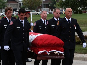 Firefighters from across the GTA along with many family and friends bid farewell to Markham firefighter Dominic Parker, who was stabbed to death at a Danforth Cafe in September 2013. (Dave Thomas/Toronto Sun)