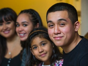 Fabian Andrade-Meza, 17, poses with his family at their home in Toronto on Dec. 10, 2015. From the left is mom Jessica Meza,sisters Tatiyana Andrade-Meza, 13, and Aaliyah Andrade-Meza,8. (Ernest Doroszuk/Toronto Sun)