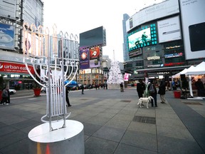 A menorah and a Christmas tree are part of the decorations at a the Yonge-Dundas Square on Thursday December 10, 2015. Michael Peake/Toronto Sun