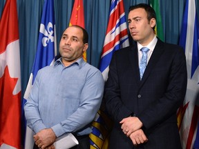 Mohamed Harkat (left), who was arrested and detained under a secret trial Security Certificate, stands with lawyer Leo Russomano during a press conference to mark the 13th anniversary of his detention and International Human Right's Day on Parliament Hill in Ottawa on Thursday, Dec. 10, 2015. THE CANADIAN PRESS/Justin Tang
