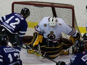 Sarnia Legionnaires goalie Aidan Hughes makes a save against Austin Kemp of the London Nationals with Legionnaires defenceman Brad Yowart nearby during the Greater Ontario Junior Hockey League game on Thursday Dec.10, 2015 in Sarnia, Ont. Hughes was pulled in the first period after allowing three goals, including one to Kemp, on 11 shots. Terry Bridge/Sarnia Observer/Postmedia Network
