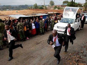 Pope Francis waves as he arrives at the Kangemi slums on the outskirts of Kenya's capital Nairobi, November 27, 2015. REUTERS/Goran Tomasevic