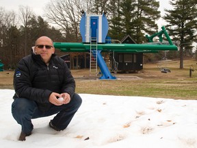 Greg Strauss, a member of the management team at Boler Mountain, squats in a small drift of artificial snow, a remnant of a night spent testing their snow-making equipment. Now all they need is cold weather, and there?s none in the forecast. But Strauss notes that weather can change on a dime. (MIKE HENSEN, The London Free Press)