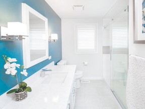 This bathroom remodel features crisp white cabinets, recessed medicine cabinets, an accent wall in turquoise, a colour picked up in artwork on the opposite wall, and a custom tiled shower. (Designer: Cassandra Nordell/Copyright William Standen Co. 2015)